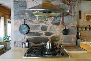 The back of the stone fireplace adds special detail to the kitchen