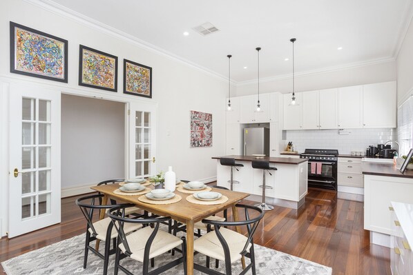 A glorious high ceiling kitchen and dining area, ready to house large families and their needs.