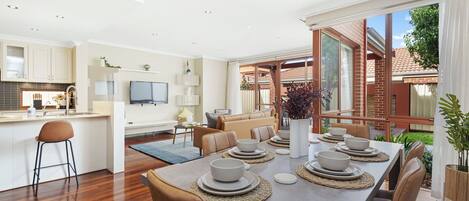 Large open plan kitchen, living and dining area extends to relaxed outdoor dining. 