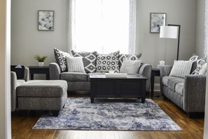 Living room with two couches and an oversized chair