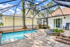 A cozy and private screened pool is located off the kitchen and the front of the home.