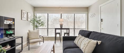 Living room with sleeper sofa and view of the pool