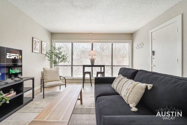 Living room with sleeper sofa and view of the pool