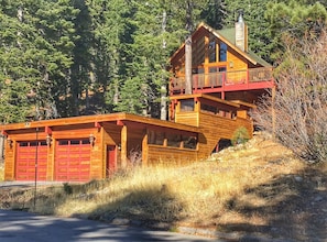 A-Frame chalet with enclosed walkway and attached large garage. 