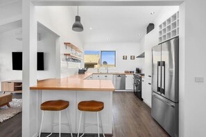 The kitchen is a cook’s dream with high-quality appliances, including a Belling oven, and a coffee machine