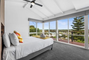 The upstairs master bedroom features a Queen bed, ensuite, and stunning dune views
