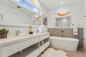 Bathroom s Primary bedroom, with an ample bath, and his and hers showers.