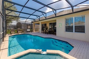 A relaxing retreat with a pool and hot tub, where ample sunlight enhances your leisure experience.