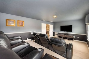 A comfortable TV room featuring great individual seating arrangements, perfect for relaxation and entertainment.