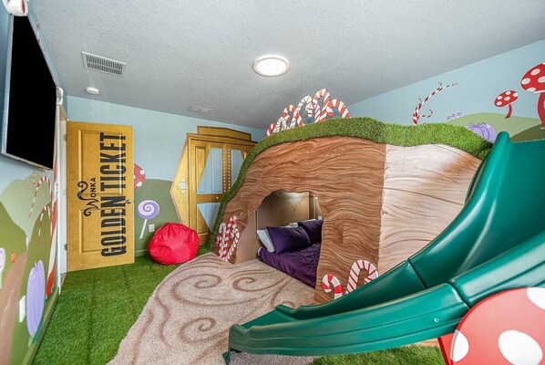 A playful bedroom featuring an exciting slide, creating a unique and adventurous space for relaxation and fun.