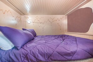 Step into a whimsical world with a Willy Wonka-themed bedroom, complete with two full beds for a delightful and enchanting stay.