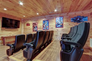 Theater room with stadium seating, 4k Smart TV, and dimmable lights