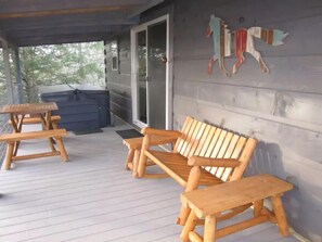 Private Treehouse Porch with hot tub, gas grill, and cedar log furniture