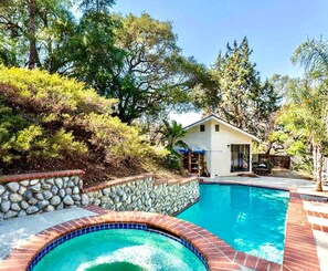 Pool spa hot tub jacuzzi spillover. Structure is main house, apt unit is down steps toward right in this photo