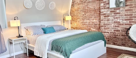 Comfy queen bed with nightstands and ambient lighting