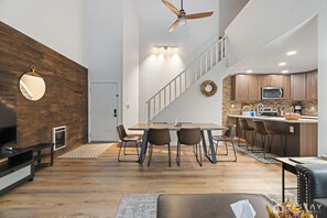 Experience the open concept design seamlessly connecting the living room, dining area, and kitchen, creating a spacious and inviting atmosphere for gathering and entertaining.