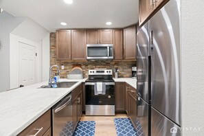 Featuring new stainless steel appliances and stunning quartz countertops for a touch of elegance.