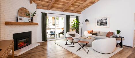 Living room with a Smart TV, warm fireplace, and comfortable seating.