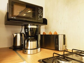 A compact kitchen setup with everything you need to enjoy morning coffee or a quick meal.