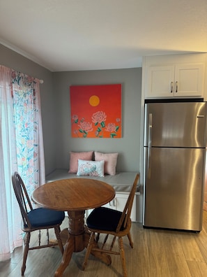 Table with seating for 4. Full sized refrigerator with ice maker.