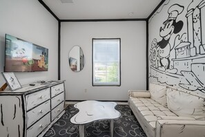 Kids will love their own space in this vibrant Mickey-themed bunk room with their own sitting area.