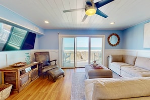 Sectional with loads of seating, flat screen tv and ocean views from this lovely living room