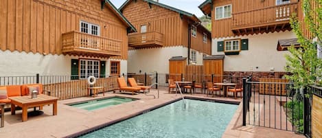 The pool and hot tub area, located right next to this condo, is a relaxing place to enjoy the day!  There is a common BBQ grill as well.