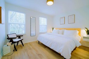Master bedroom features a plush king bed, full length mirror and tons of natural light.