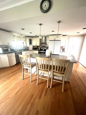 Large kitchen well equipped kitchen with island seating . 