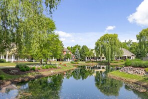 Enjoy the serene pond and beautiful greenery on this tranquil property.