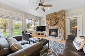 Curl up and unwind by the cozy fireplace in our warm and inviting living room.