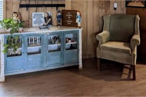 smart TV, vintage Wizard of Oz memorabilia and seating area near kitchen