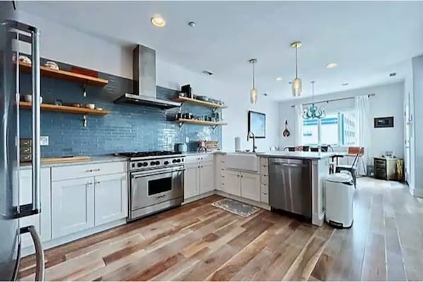 New kitchen with large range and full size refrigerator