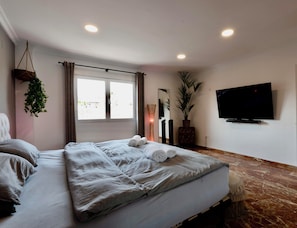 The Paris Suite (Emperor Bed), 65” TV, Surround Sound, and closet space.