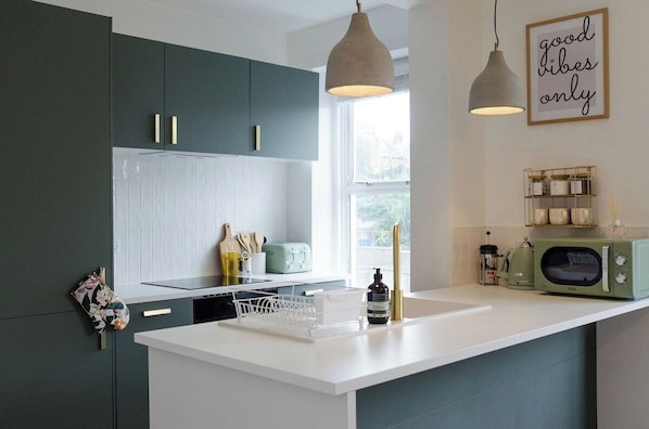 Enjoy cooking in our  sleek white counter serves as the perfect canvas for homecooked meals