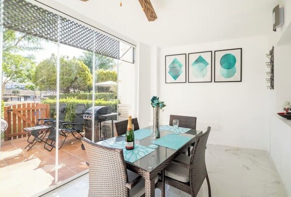 Conservatory area with glass curtains leading onto the private garden   