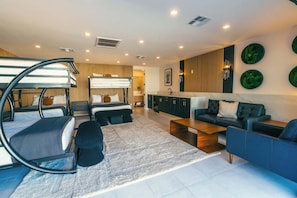 Stylish modern bunk room with its own lounge and private en suite bathroom — ideal for kids, friends, or the whole crew.