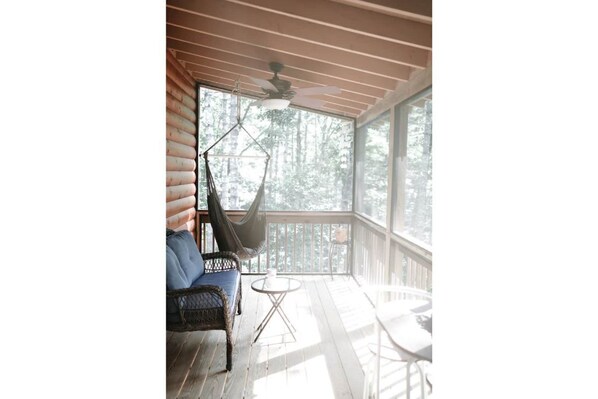 Screened in porch where our guests love to start their day with a cup of coffee.