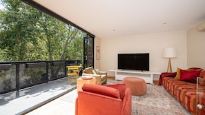 Living room with an abundance of natural light and balcony