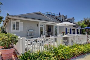 Side view of the house including the patio and french doors leading into the house 