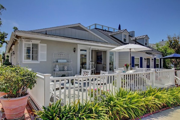 Side view of the house including the patio and french doors leading into the house 