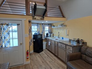 Kitchenette and loft with ladder raised.