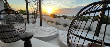 Watch the sunset from the swing chairs