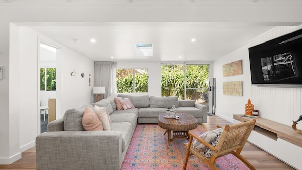 Spacious lounge area with large L-shaped sofa