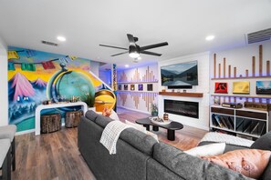 Living room serenity: A mural odyssey meets vinyl vibes, synchronized with LED enchantment.