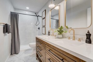 Well-lit and designed toilet and bath.