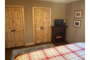 Master suite with fireplace and TV