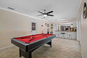 The centerpiece of this game room, a sleek and stylish pool table that's sure to impress.