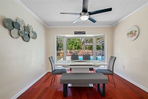 The sleek and minimalist dining table, surrounded by comfortable chairs, invites you to gather around and indulge in a delicious meal with your loved ones.