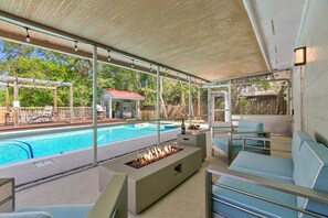 This patio by the pool is the perfect spot to relax and enjoy a little shade while sipping on a cold drink and enjoying the sights and sounds of the pool area. (Fire feature disabled per insurance requirements)